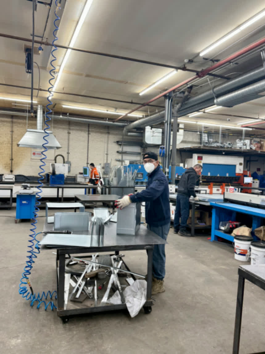 HVAC duct fabrication shop — sheet metal production floor with visible ductwork